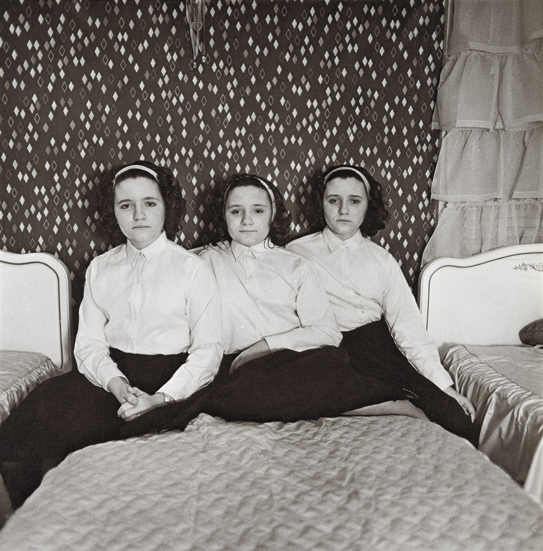 DIANE ARBUS - Triplets In Their Bedroom, NJ, 1963: Artist: Diane Arbus Title: Triplets In Their Bedroom, NJ, 1963 Medium: Photo Litho, 1972, USA Dimensions: 8.25x8.4" Description: Heat Wax Mounted on 11x14" Conservation Board Artist Bio: Diane Arbus w