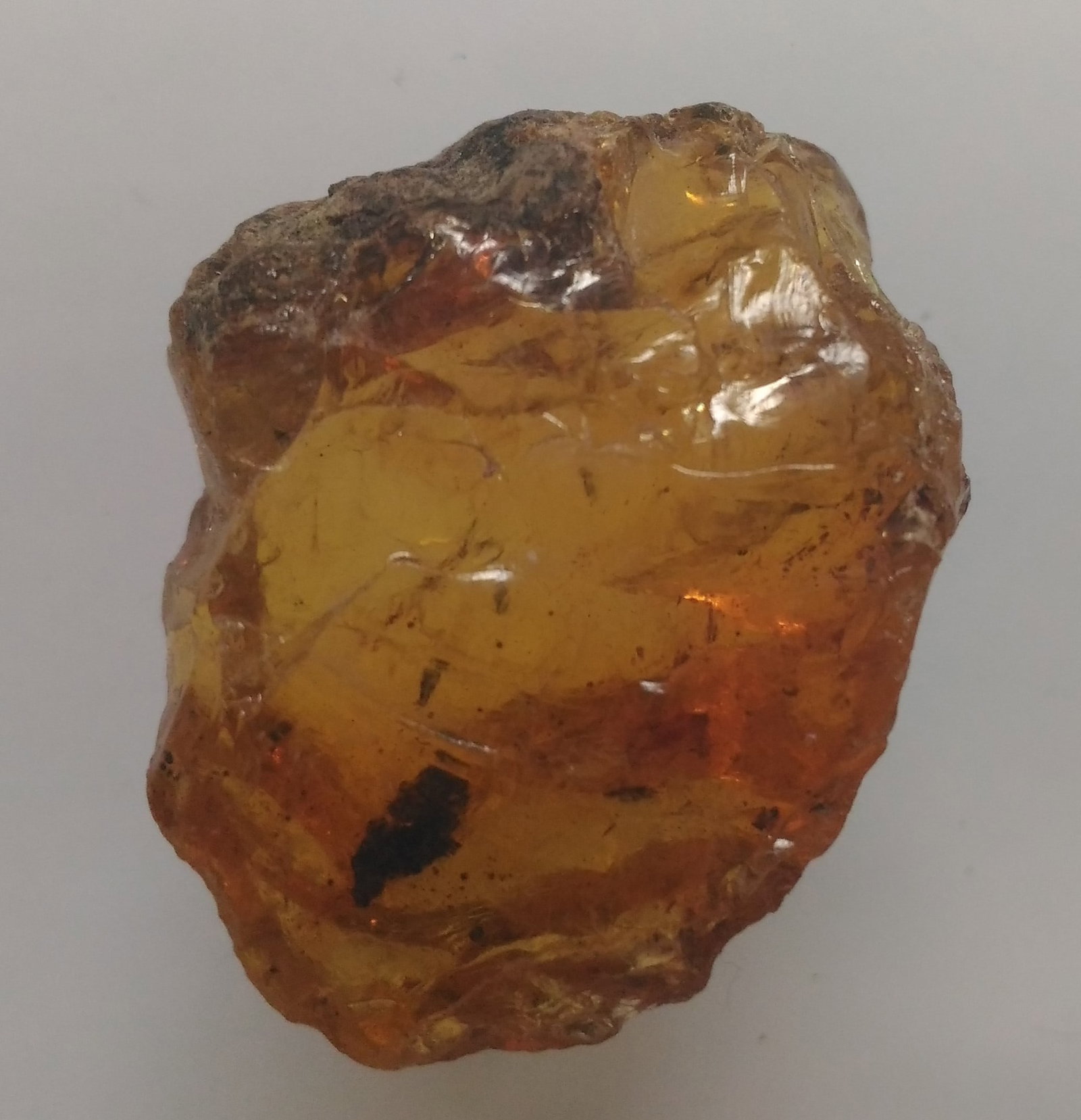 4.27 Gram 100 Mill. Years Old Rough Burmite Amber: Title: 4.27 Gram 100 Mill. Years Old Rough Burmite Amber Origin: Hukawang Valley, Kachin State, Myanmar Size: 2.5x2x1 cm / 4.27 gram Description: clear yellow rough burmite amber with minor black matr