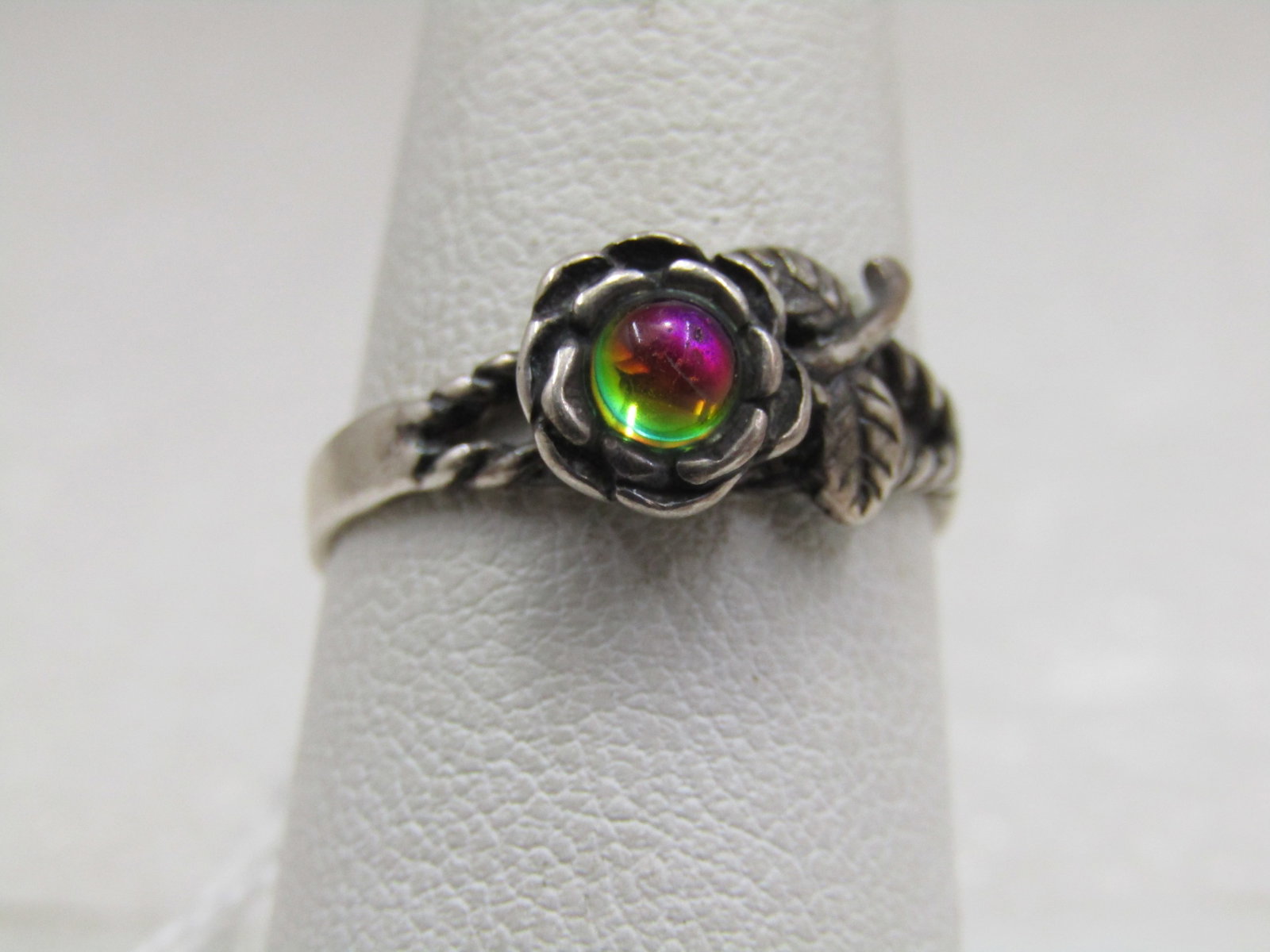 Sterling Created Mystic Topaz Rose Ring, Sz. 8.: Sterling created mystic topaz rose ring, sz.8. Round nearly 4mm created mystic topaz in the middle of a rose blossom with leaf and stem accent, split rope accent band on top. Signed with a $ inside a 