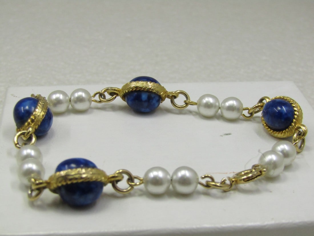 Vintage Faux Pearl & Sodalite Bracelet, 7.5": Vintage Faux Pearl & Sodalite Bracelet, 7.5". Each of the blue beads that look like sodalite - not sure if glass or sodalite, are appx. 9.5mm by 7.5mm with a textured gold tone bezel around them conne
