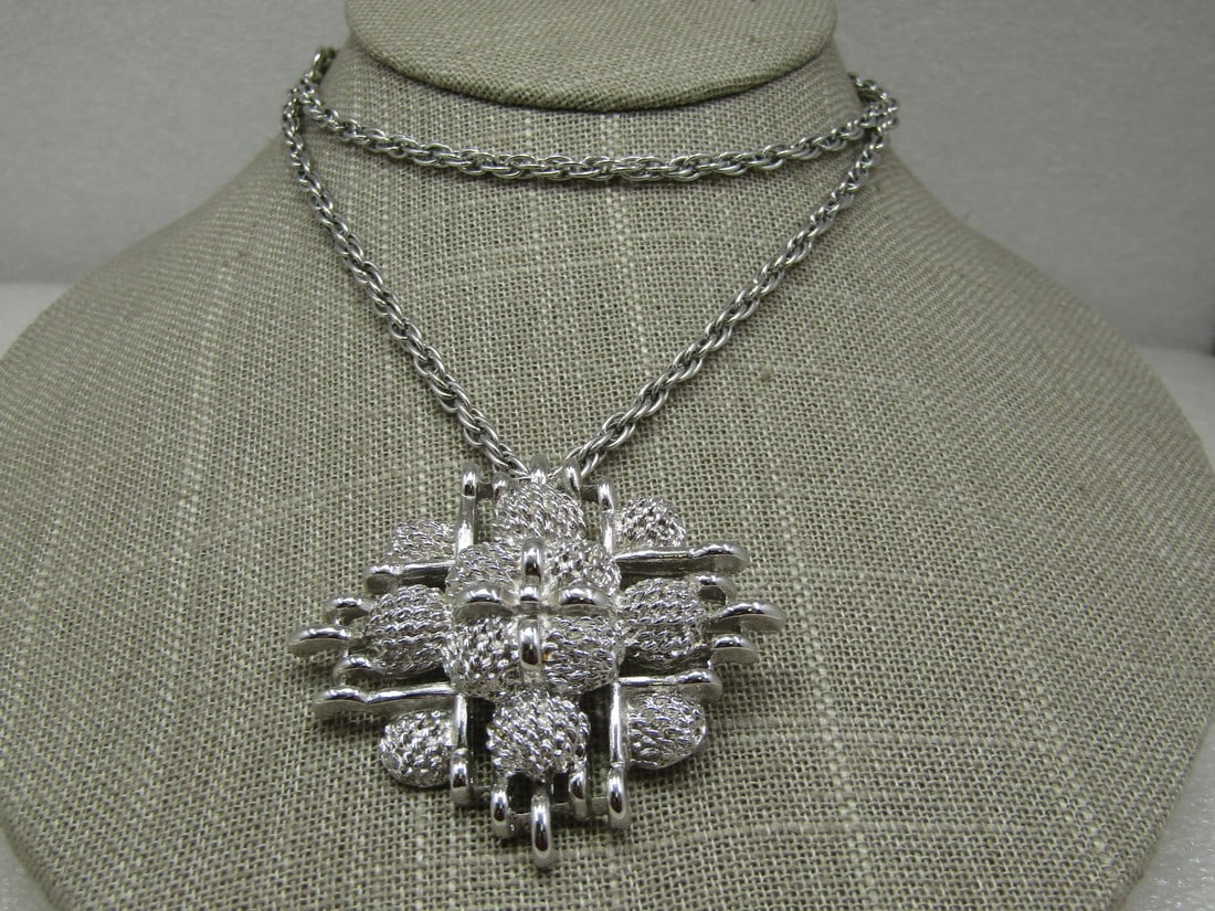 Vintage Monet Mod Cross Pendant Necklace, 24" Silver Tone: Vintage Monet Mod Cross Pendant Necklace, 24" Silver Tone. 1970's-1980's. The pendant is a tiered textued crosslike shape that has a smaller smooth cross as the center and then also a larger grid-like