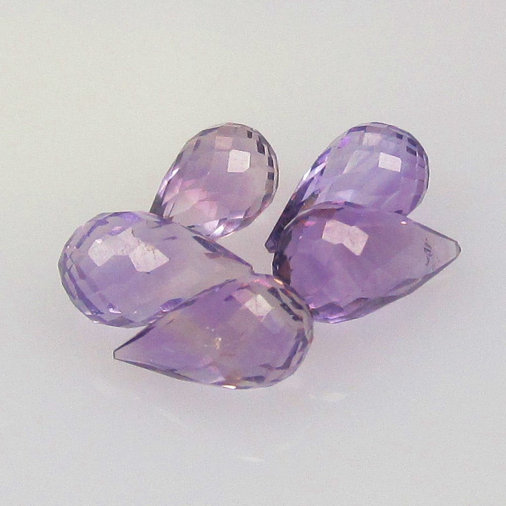 4.27 Ctw Natural 5 Drilled Purple Amethyst Pear Drop Beads: No Reserve! Title: 4.27 Ctw Natural 5 Drilled Purple Amethyst Pear Drop Beads Stone clarity: Transparent Gemstone:Natural Amethyst Beads Carat weights: 4.27 Size/Dimensions: 7.4x4.3 - 8.3x5.0 mm / 5 P