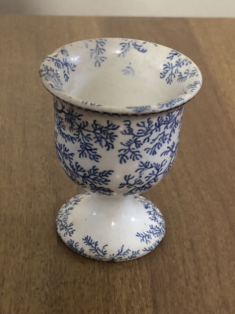 Staffordshire egg cup: It measures 2 1/2” x 2” and dates around the 1830’s. It has discoloration and two small chips on the rim top rim. Otherwise it has no other issues Shipping: Domestic: Flat-rate of $1