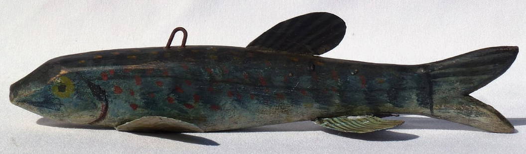 A good sized fish decoy, carved from wood with great paint: This is a good sized fish decoy, carved from wood with metal fins. It is painted shades of blue, with red, gold, yellow, and black detail. There is an old chip out of one side of the tail. The decoy i