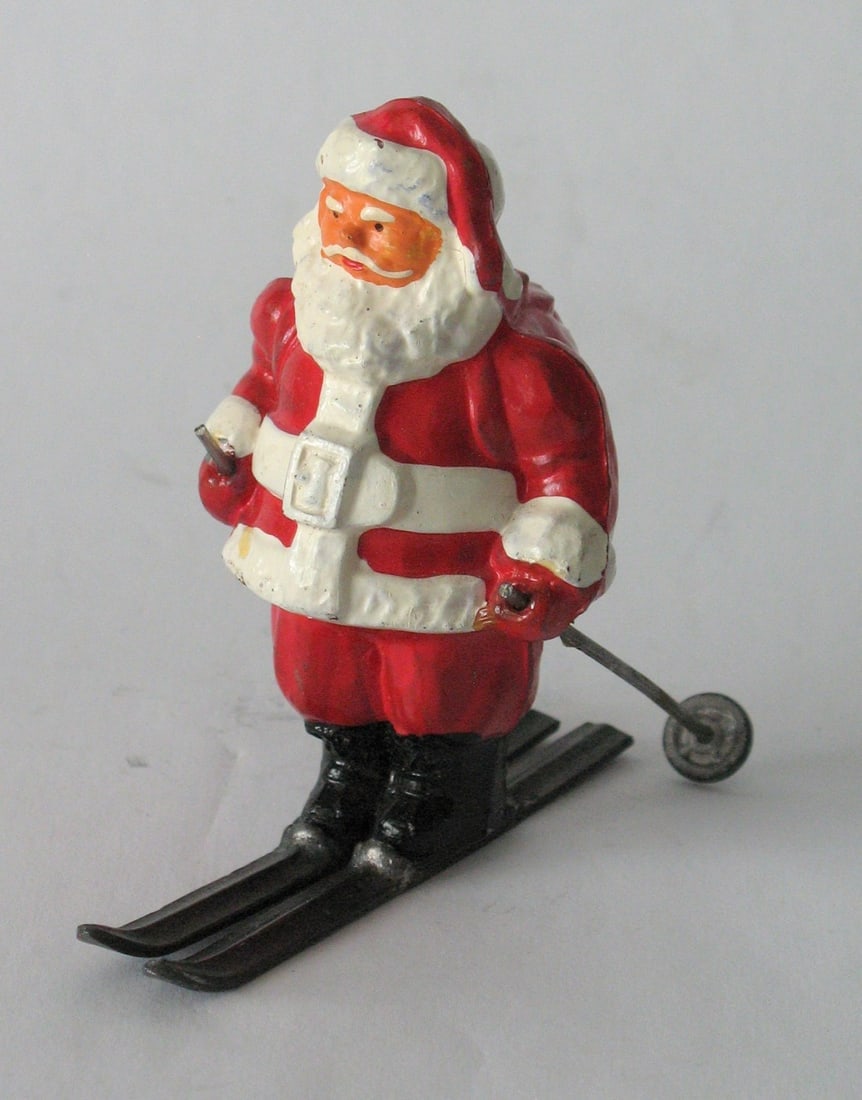 Antique cast metal Santa on skies Christmas décor. (1 of 3)