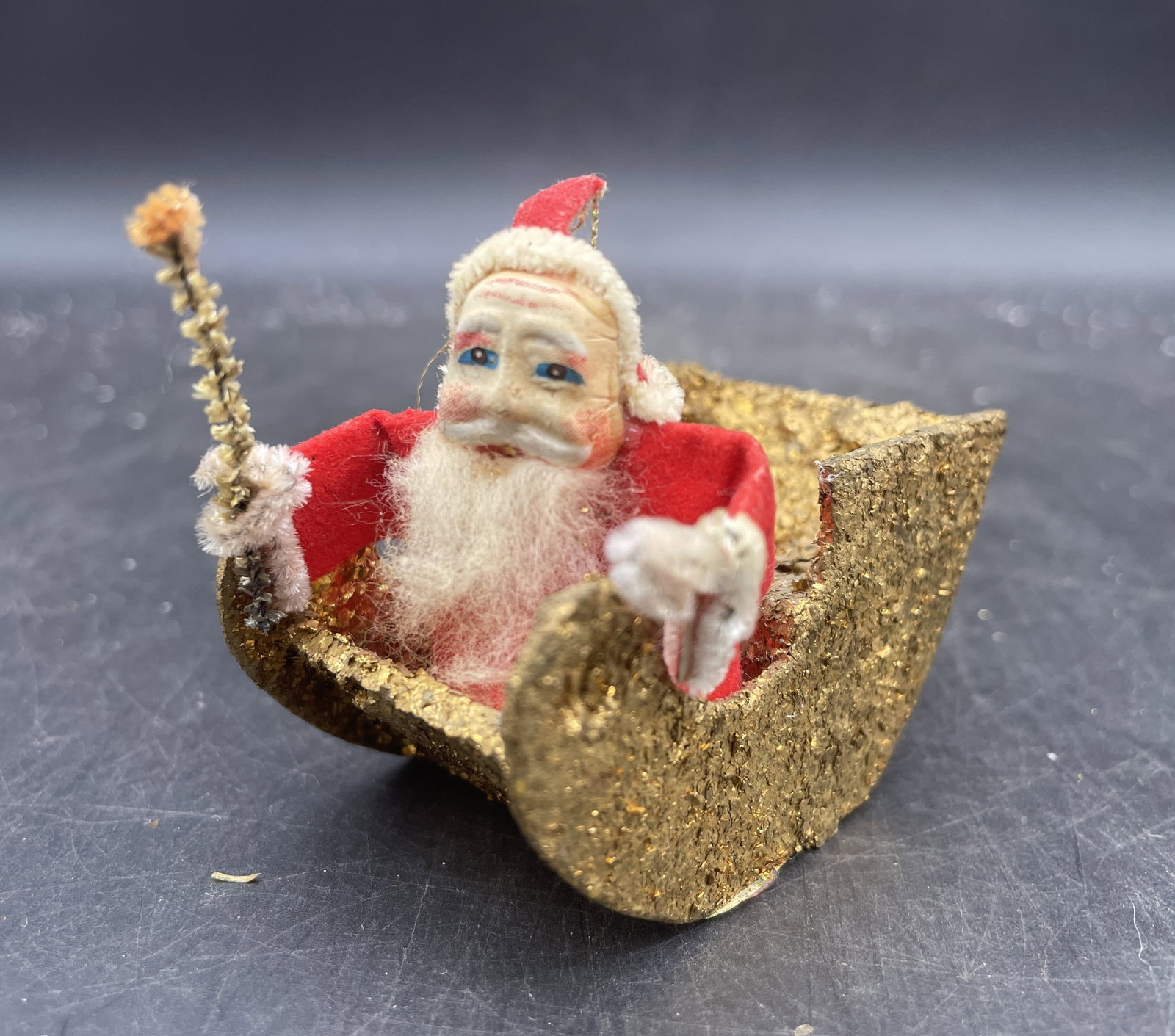 1950's Christmas Celluloid face Santa Claus in Gold Mica Sled: Title: 1950's Christmas Celluloid face Santa Claus in Gold Mica Sled Date/Period: approx 1950's Dimension: Approx 2.5 x 2 Material: mixed materials Additional Information: 1950's Christmas Celluloid f