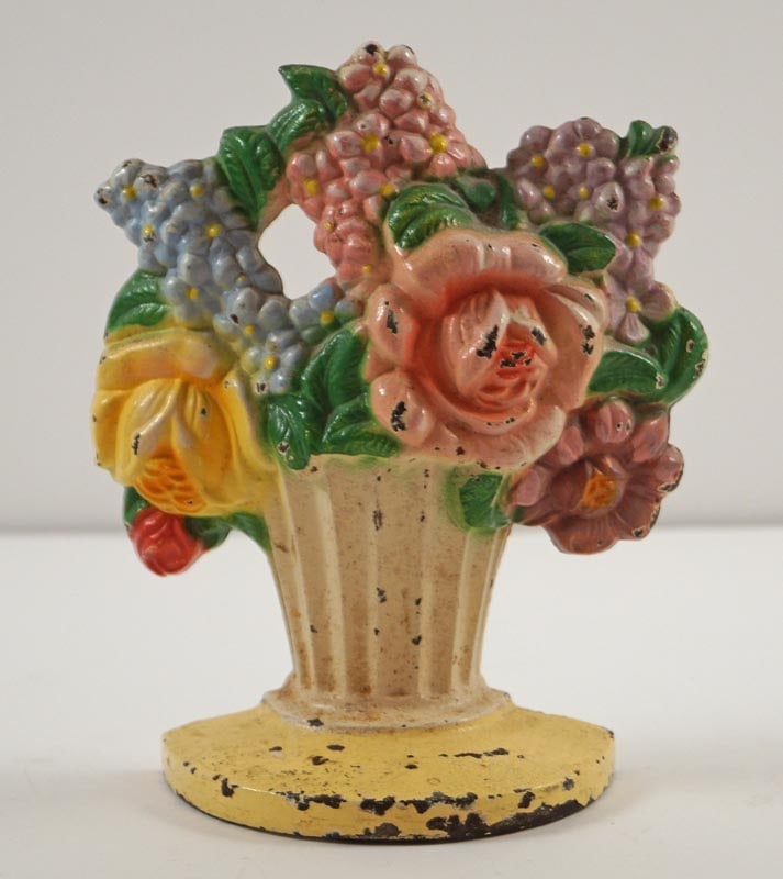 Roses w/ Mixed Flowers Cast Iron Hubley Doorstop: Title: Roses w/ Mixed Flowers Cast Iron Hubley Doorstop Dimension: 5 ½” tall x 4 1/8” wide. Date: Ca. 1930’s. Additional Information: Multi-colored Mixed Flowers in fluted Baske