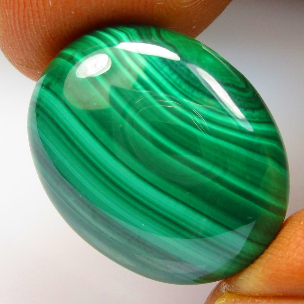 23.81 Ctw Natural Malachite Oval Cab: No Reserve! Title: 23.81 Ctw Natural Malachite Oval Cab Stone Clarity: Opaque Gemstone:Natural Malachite Carat Weights: 23.81 Size/Dimensions: 20.40 x 16.30 x 5.90 mm Additional Info:Excellent Oval Ca