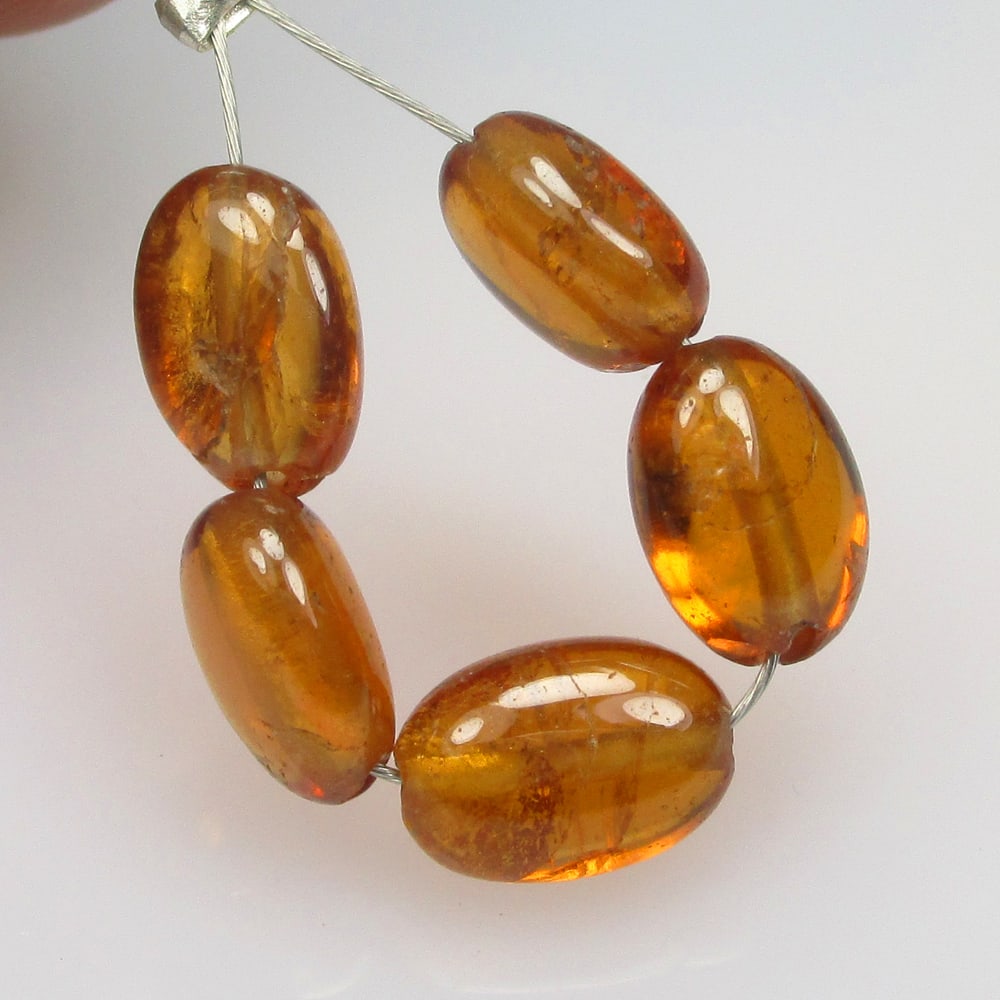 6.87 Ctw Natural 5 Hessonite Garnet Dumble Beads: No Reserve! Title: 6.87 Ctw Natural 5 Hessonite Garnet Dumble Beads Stone Clarity: Transparent Gemstone:Natural Hessonite Garnet Beads Carat Weights: 6.87 Size/Dimensions: 5.3x3.5- 5.6x3.6 mm / 3 Pc's