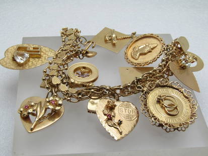 Vintage 14kt Charm Bracelet, 14 charms, 7", 1960's, 80.41gr.: Vintage 14kt Charm Bracelet, 14 charms, 7", 1960's, 80.41gr. This a 13.5mm wide textured hearts down the center and beaded triple rings in each link. The thumb tab is also a heart. It apparently belon
