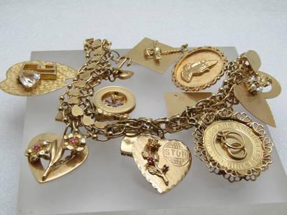 Vintage 14kt Charm Bracelet, 14 charms, 7", 1960's, 80.41gr.: Vintage 14kt Charm Bracelet, 14 charms, 7", 1960's, 80.41gr. This a 13.5mm wide textured hearts down the center and beaded triple rings in each link. The thumb tab is also a heart. It apparently