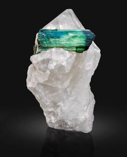 Stunning Green Tourmaline Encased in Quartz: A Natural Wonder of Color and Clarity: Treatment: None Condition: Natural Name: Tourmaline, Quartz Color: Green Weight: 4686 Grams Size: 260x140x130 m.m Shape: Specimen Reserve: $2,500.00 Shipping: Domestic: Flat-rat