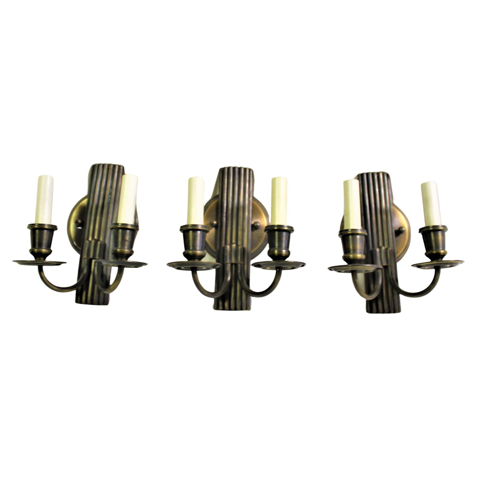Art Deco/Modern Sconces Two Arm Set: Art Deco designed cast in bronze with two arm lights. Solid brass parts, all with multi-patina finish. Set of 3 from a Lighting showroom. 3 " candelabra sockets and covers. At a height of 9" and 8" wi