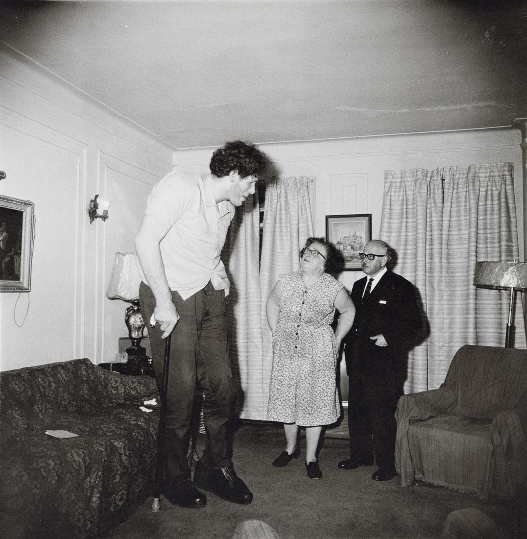 DIANE ARBUS - Jewish Giant at Home With Parents, 1970: Artist: Diane Arbus Title: A Jewish Giant At Home With His Parents In The Bronx, New York, 1970 Medium: Photo Litho, 1972, USA Dimensions: 8.3x8.5" Description: Heat Wax Mounted on 11x14" Conservation