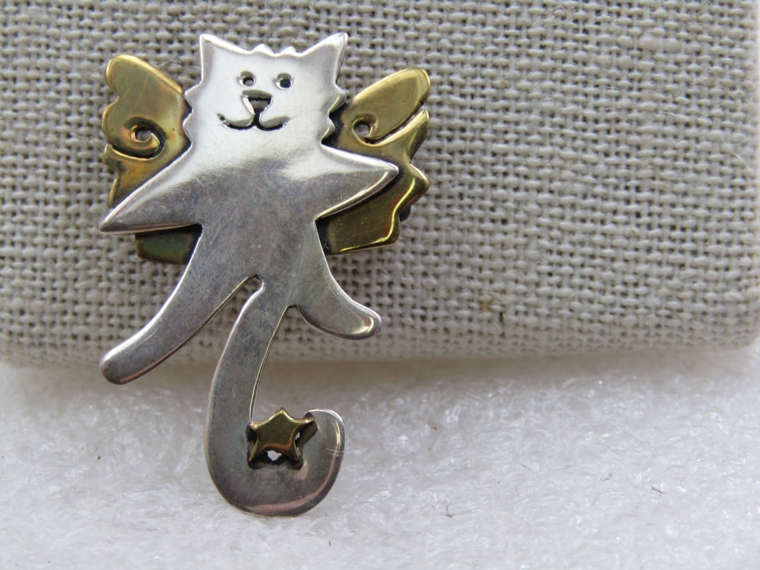 Cat Angel Brooch, Signed Far Fetched, Two Tone: Cat Angel Brooch, Signed Far Fetched, Two Tone. 1.5" Long and 1" wide with gold tone wings and star sitting in the curl of the cat's tail. The cat is silver tone. Very cute brooch and in very good con