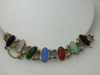 Vintage Egyptian Themed Scarab Bracelet, 6.75", Glass Scarabs, Gold Tone, 1960's-1970's: Vintage Egyptian Themed Scarab Bracelet, 6.75", Glass Scarabs, Gold Tone, 1960's-1970's. The scarabs are pressed glass in the colors of onyx, rose quartz, jade, blue chalcedony, carnelian, lighter gre