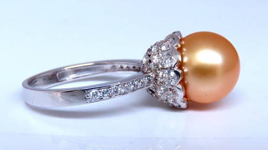 10.3mm Natural Golden South Seas Pearl Diamonds Rings 14kt: 10.3mm Natural South Seas Gold / Yellow Pearl Ring .70ct Natural Round Diamonds 14kt. white gold 4.3 grams. Current ring size: 5.5 We may resize. Depth of ring: 14mm $6000 Certificate of Appraisal to