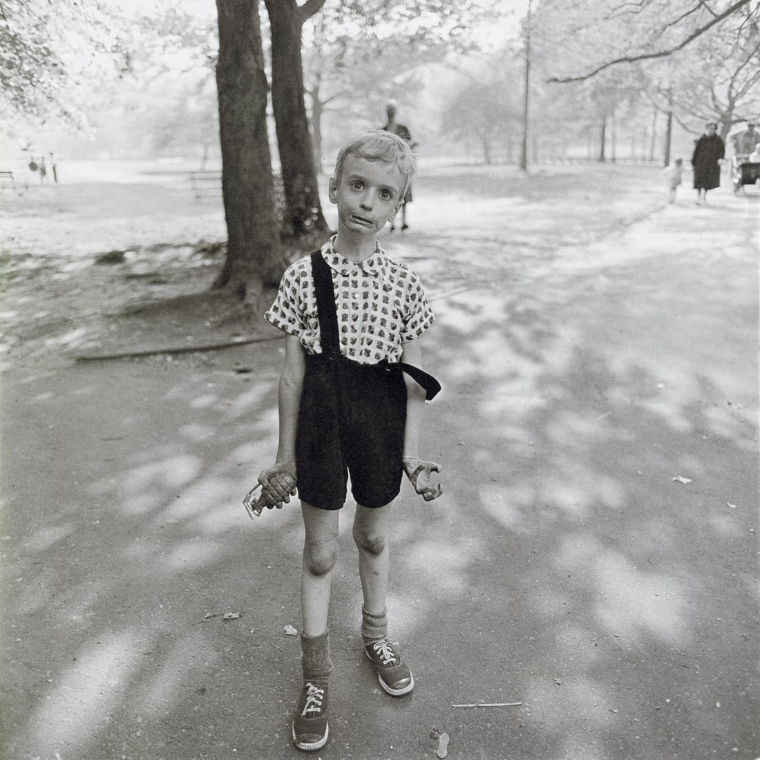 DIANE ARBUS - Child with a Toy Hand Grenade, 1962: Artist: Diane Arbus Title: Child with a Toy Hand Grenade in Central Park, NYC, 1962 Medium: Photo Litho, 1972, USA Dimensions: 8.4x8.4" Description: Heat Wax Mounted on 11x14" Conservation Board Artis