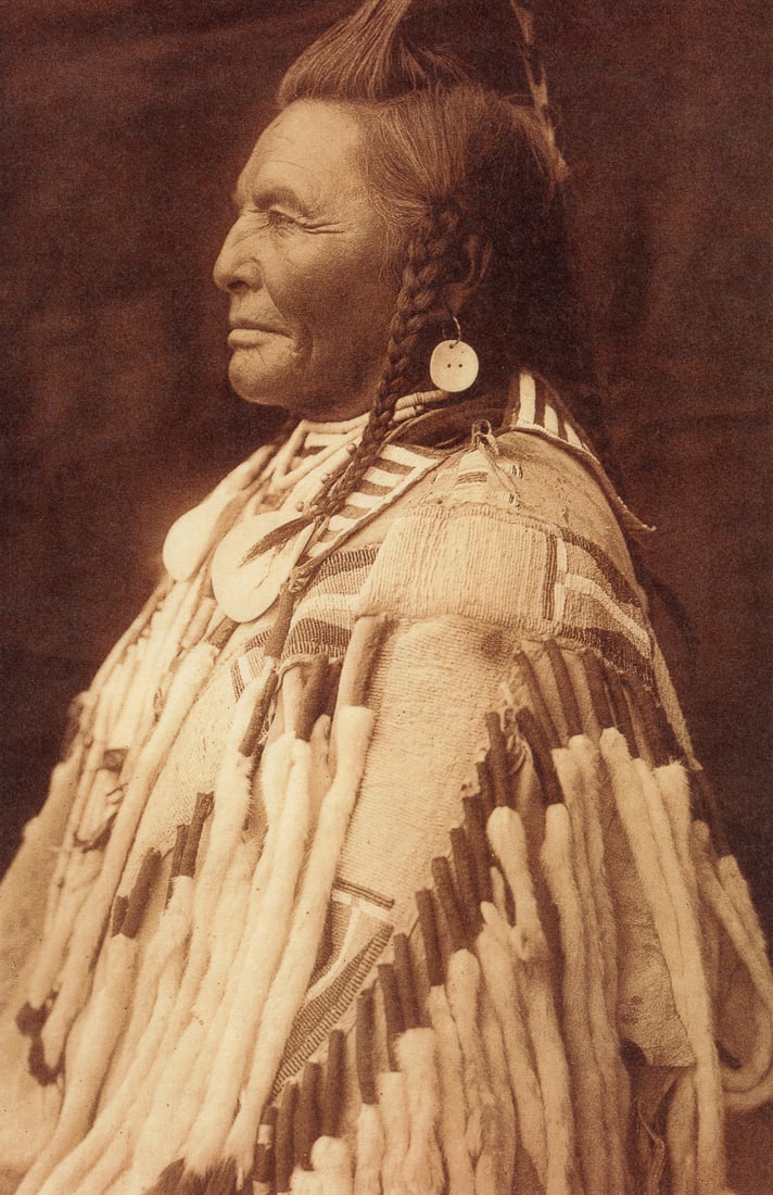 EDWARD CURTIS - Shot in the Hand - Asparoke, 1908: Artist: Edward Curtis Title: Shot in the Hand - Asparoke, 1908 Medium: Photo Litho, 2000, Canada Dimensions: 6.45x10" Description: Heat Wax Mounted on 11x14" Conservation Board Artist Bio: Edward Sher
