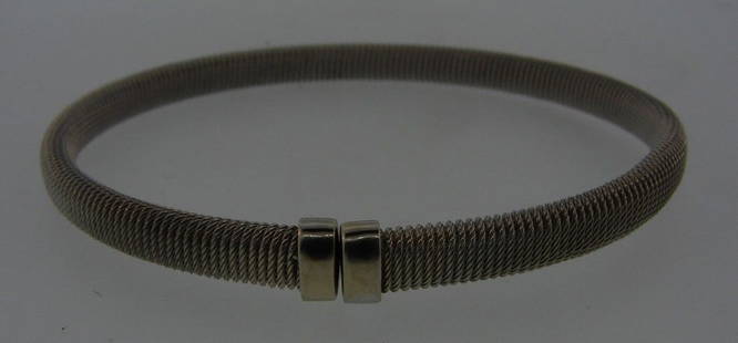 CHIC Italian 14k White Gold Mesh Bangle: DK 14k White Gold Mesh Bangle Italy · Wonderful bangle that is a necessity in your collection. · The weight is 11.6 grams. · The length is 7 inches. The height is 3/16 of an inch. The w
