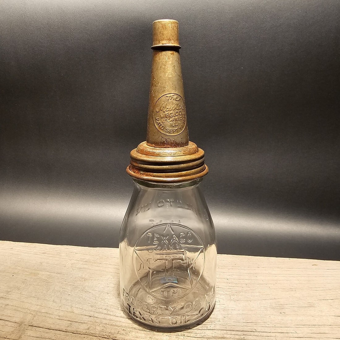 Texaco Glass Oil Bottle w Spout: 11" Tall 4" Wide Such a neat reproduction glass oil bottle. Wonderful signs of wear and distress. Hard to tell its age! Looks great on display! All our items come with a 100% customer satisfaction gua