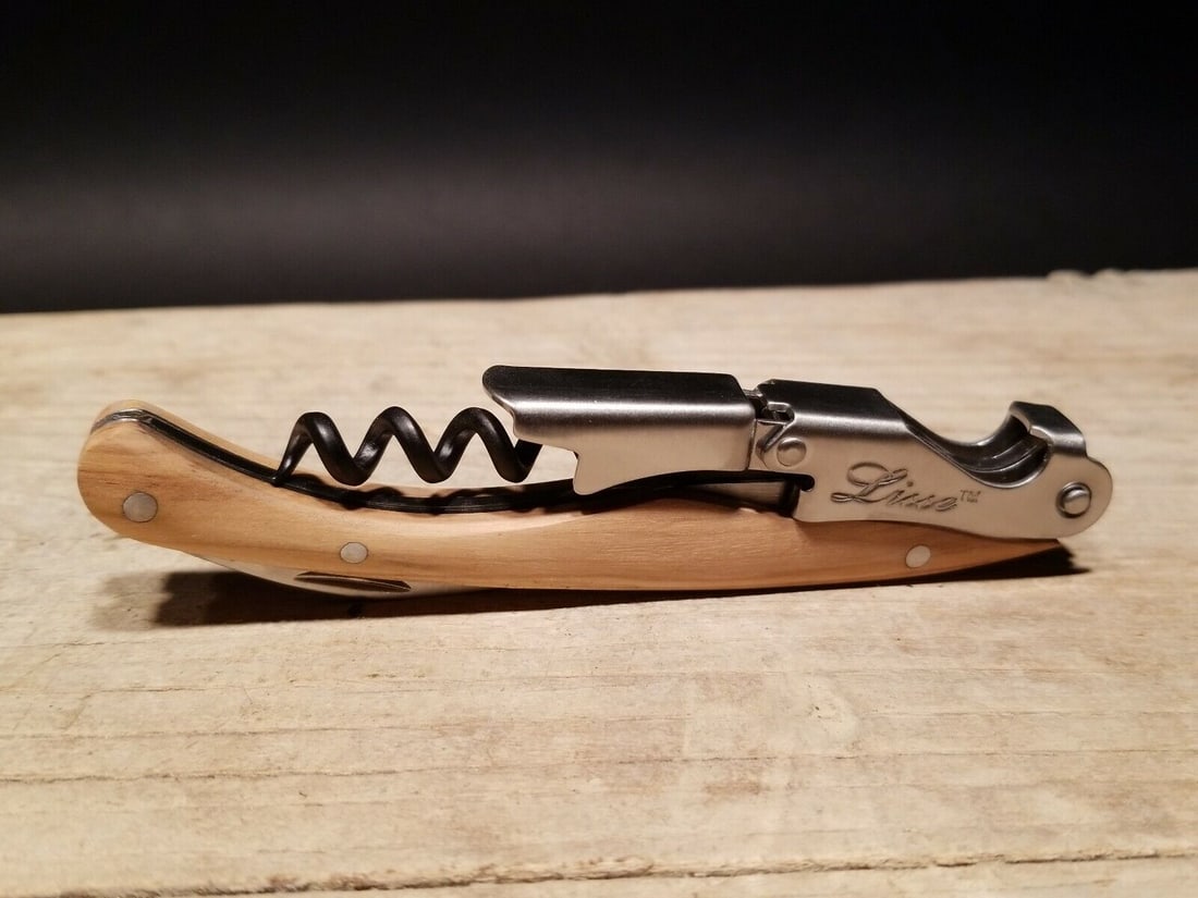 Corkscrew with Olive Wood Handles: 4 3/4" long x 5/8" Wide Nice quality, brand new, never used heavy waiters style corkscrew with olive wood handles. This piece is made from stainless steel and wood. An extra sharp serrated foil cutter