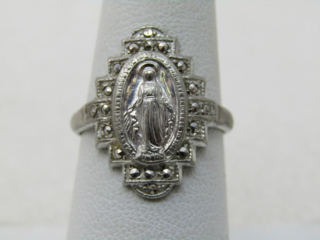 Vintage Sterling Blessed Mother Marcasite Ring, Sz. 7.25: Vintage Sterling Blessed Mother Marcasite Ring, Sz. 7.25, 4.30 grams. 20mm long and 15mm wide with a stepped frame. The band is appx. 2.5mm wide band. Marked sterling and tested. Age is appx. 1960's-1
