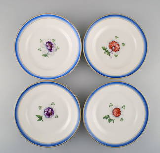 Four antique Royal Copenhagen plates in hand-painted porcelain with flowers and blue border with: Four antique Royal Copenhagen plates in hand-painted porcelain with flowers and blue border with gold. Model number 592/9051. Late 19th century. Diameter: 23.5 cm. 1st and 2nd factory quality. In