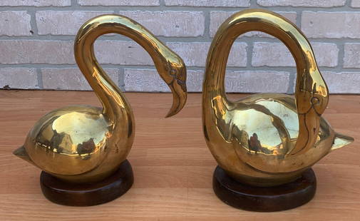 Mid Century Gold Brass Swan Figurines - Pair: Mid Century Gold Brass Swans Statues on Wood Bases - Pair Circa 1970 H 11" W 10" D 5" Good vintage condition Please be aware that all the items are vintage and may have small defects of signs