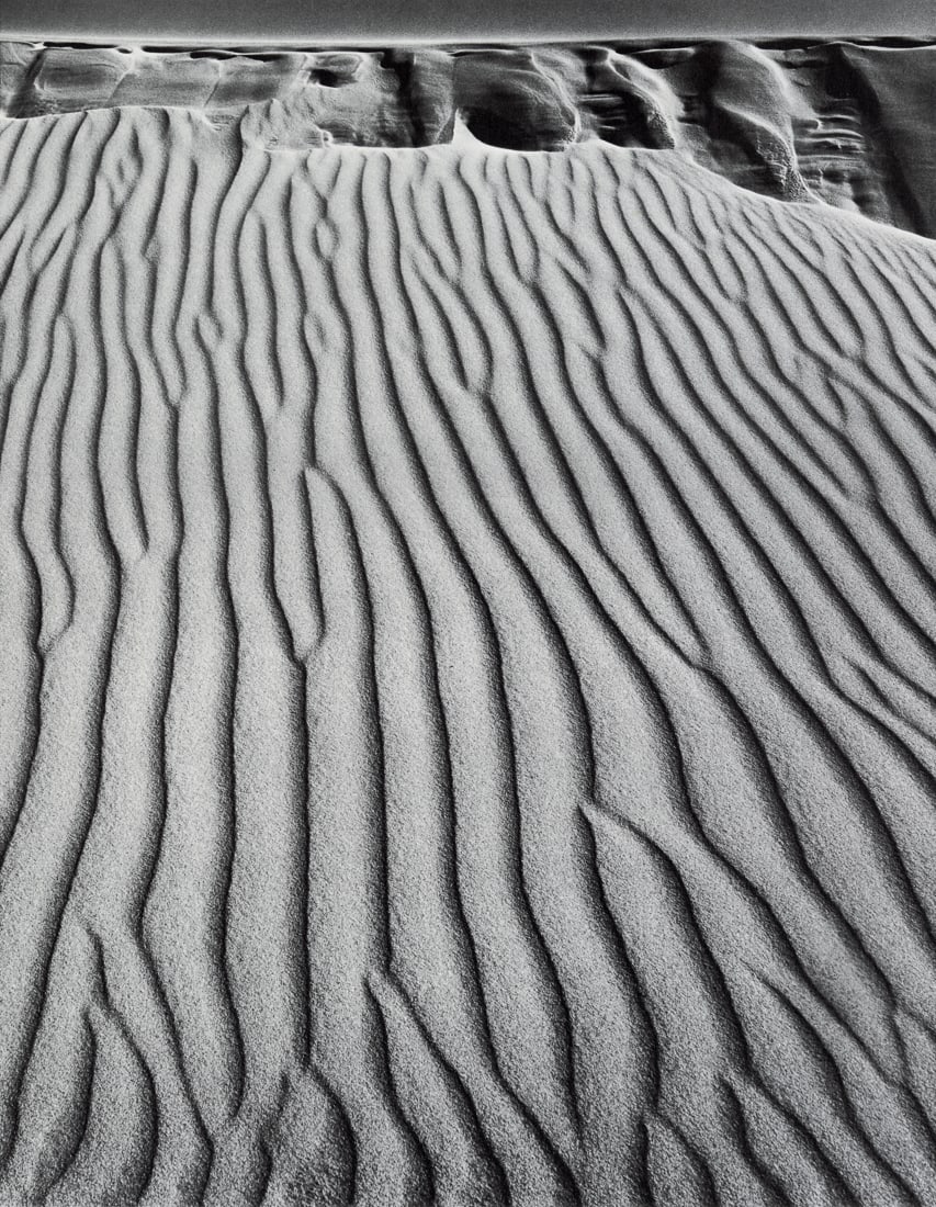 ANSEL ADAMS - Sand Dunes, Oceano, California, 1950: Artist: Ansel Adams Title: Sand Dunes, Oceano, California, 1950 Medium: Photo Litho, 1974, USA Dimensions: 9x11.65" Description: Heat Wax Mounted on 12x16" Conservation Board Artist Bio: Ansel Adams w