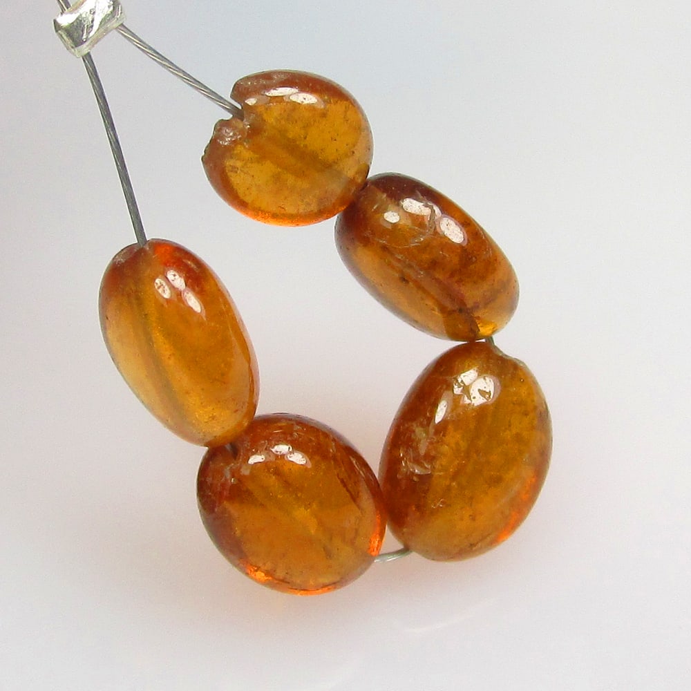7.50 Ctw Natural 5 Hessonite Garnet Dumble Beads: No Reserve! Title: 7.50 Ctw Natural 5 Hessonite Garnet Dumble Beads Stone Clarity: Transparent Gemstone:Natural Hessonite Garnet Beads Carat Weights: 7.5 Size/Dimensions: 5.5x3.5- 6.1x3.6 mm / 5 Pc's 