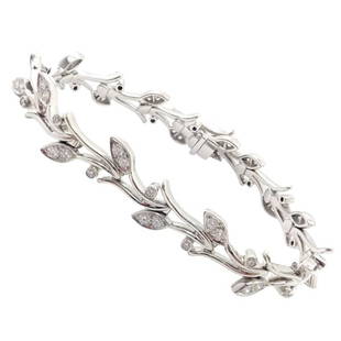 Authentic! Tiffany & Co Platinum Diamond Garland Bracelet: The Authentic Tiffany & Co. Platinum Diamond Garland Bracelet is a stunning piece of fine jewelry that features a delicate garland design set with dazzling diamonds. The bracelet is made of