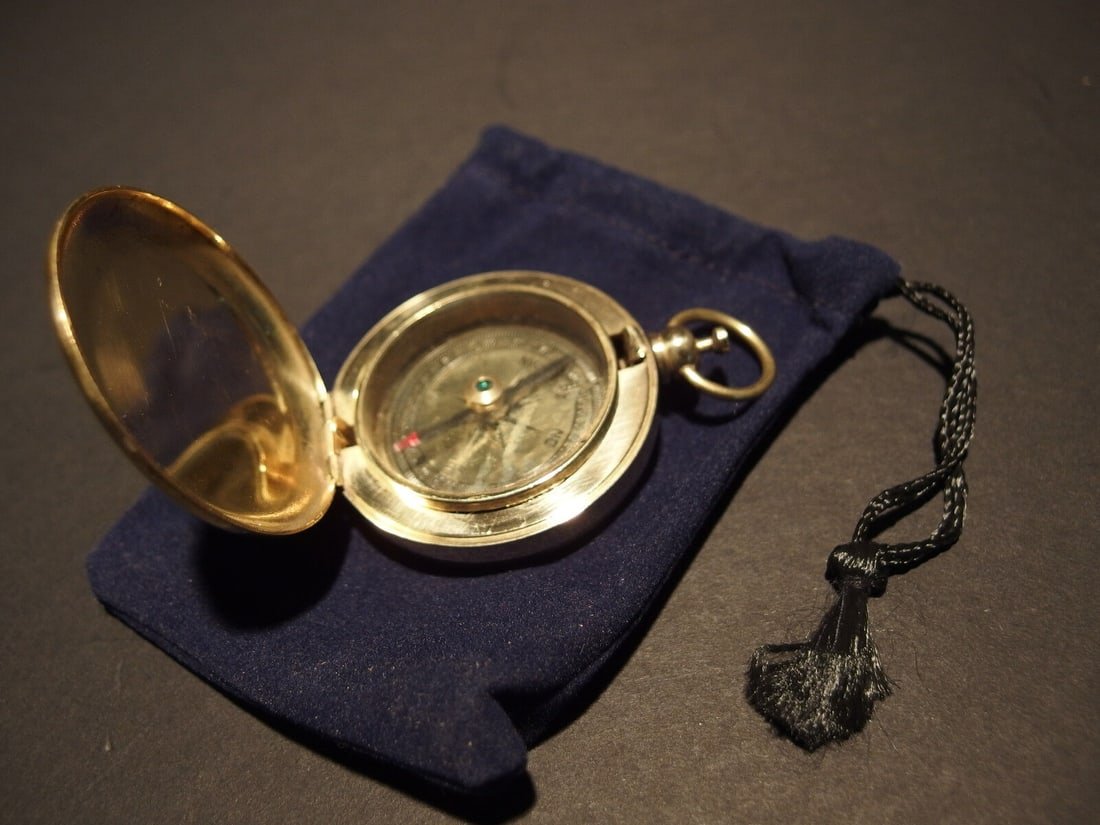 Brass Pocket Compass flip lid Signal mirror with bag: 2 1/2" tall 1 7/8" WideNice reproduction of an antique compass with pocket watch type lid. The lid opens with the push of the button on the top. When opened the polished inside of the lid makes for a 