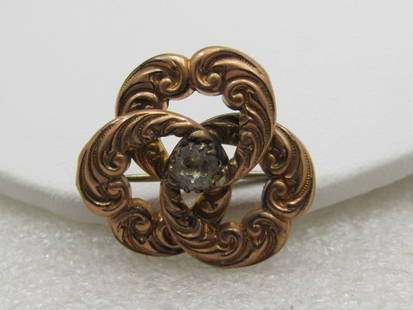 Victorian 10kt Gold Filled Love Knot Brooch Pendant, Rhinestone Center 1-1/8": Victorian 10kt Gold Filled Love Knot Brooch Pendant, Rhinestone Center, 1-1/8" with center 5.8mm rhinestone. C-Clasp. Scrolled design in each loop of the love knot. Good condition with some typical vi