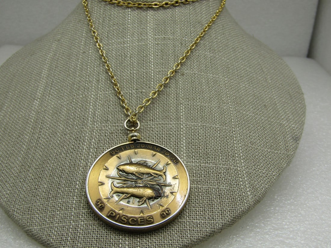 Vintage Pisces Medallion Zodiac Necklace, 24" Gold and Bronzetone: Vintage Pisces Zodiac Necklace, 24" Gold and Bronzetone. Coin bezel in gold tone with a textured 24 gold tone chain with spring clips. The coin is bronze ton with repousse design. The front has the tw