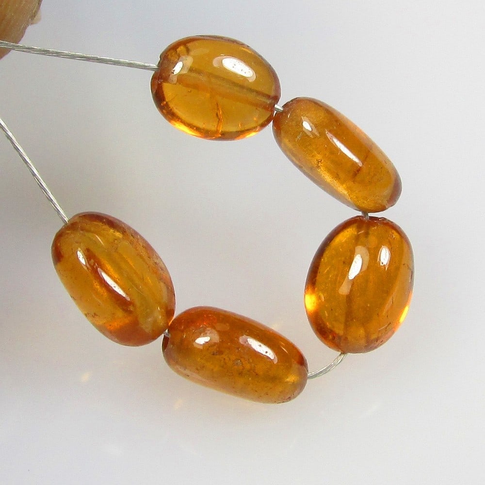6.11 Ctw Natural 5 Hessonite Garnet Dumble Beads: No Reserve! Title: 6.11 Ctw Natural 5 Hessonite Garnet Dumble Beads Stone Clarity: Transparent Gemstone:Natural Hessonite Garnet Beads Carat Weights: 6.11 Size/Dimensions: 4.6x2.8- 5.1x2.9 mm / 5 Pc's