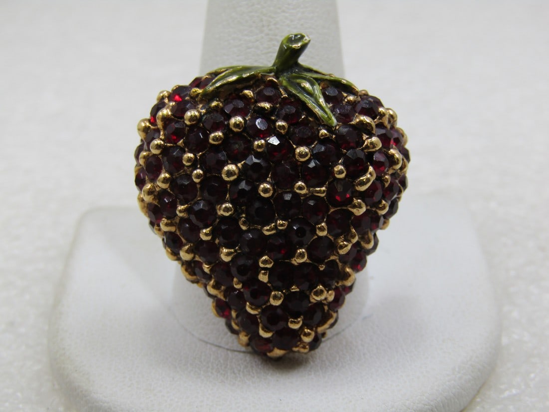Vintage Strawberry Brooch With Garnet Colored Stones, Mid-century: Vintage Strawberry Brooch with Garnet Colored Stones, Mid-Century, appx. 1.25" tall and 1" wide. Gold tone with garnet stones encrusted thoughout creating the strawbbery, rounded with green enameled l