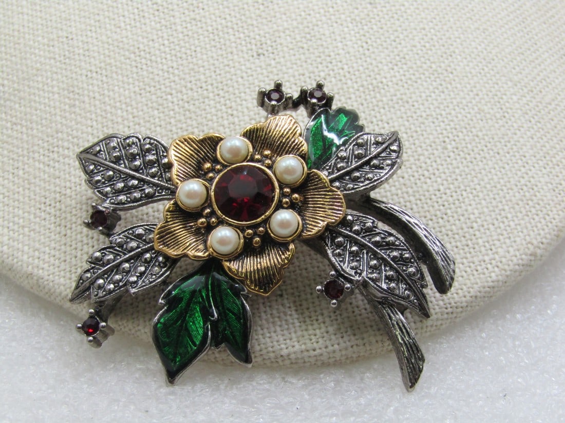 Vintage Faux Marcasite Floral Brooch, Rhinestones Faux Pearls, Avon: Vintage Faux Marcasite Floral Brooch, Rhinestones Faux Pearls, Avon, 2.5". Faux marcasite leaves with red rhinestones, faux pearls and green enameled leaves. Appx. 2.5" wide and 2" tall. A mix of silv