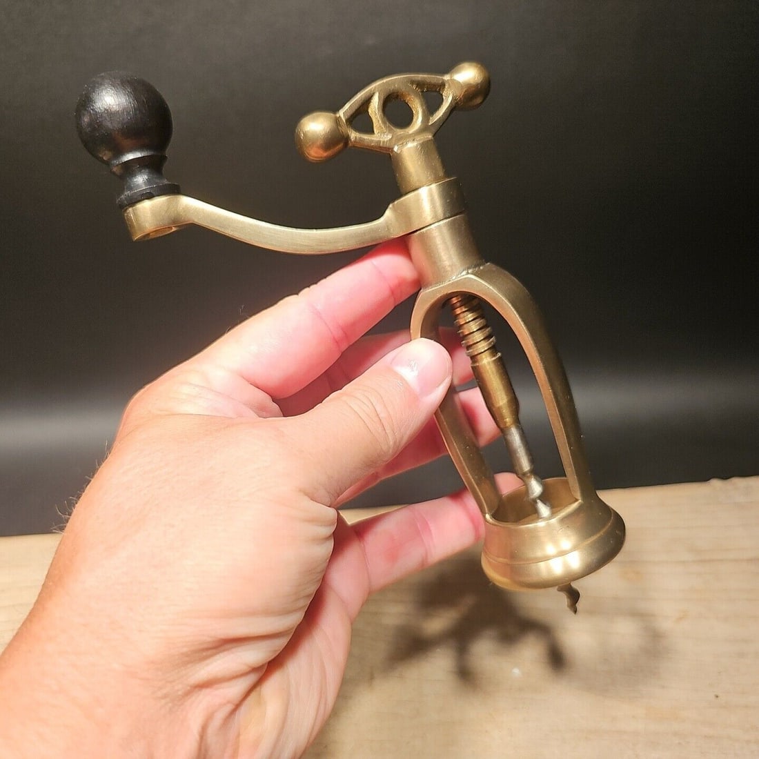 Decorative Brass Mill Crank Corkscrew Wine Bottle Opener: 6 3/4" Tall The antique reproduction brass coffee mill crank-style corkscrew. Unfortunately the design of this one doesnt allow a lift out of the cork, it only unscrews out. While it may work in some 