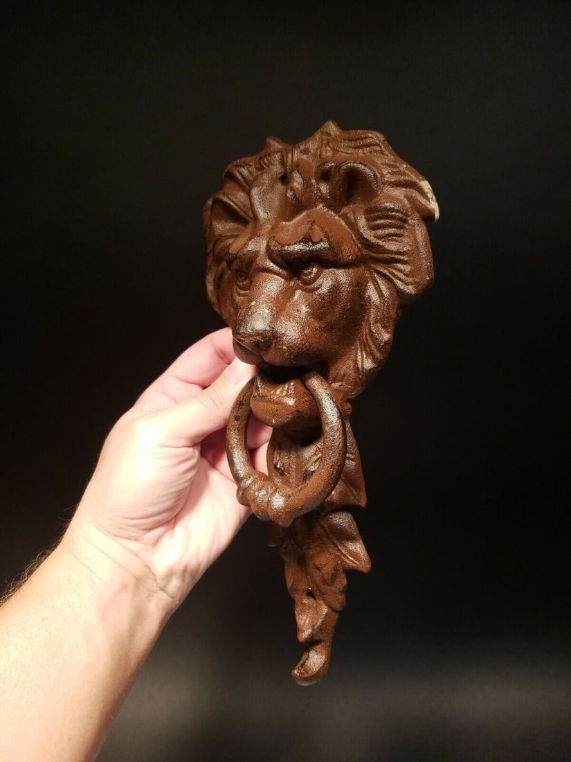 Cast Iron Lion Door Knocker w Hook: 10 3/4" Tall x 5 1/4" wide 2 lbs 7oz Nice heavy quality reproduction cast iron door knocker! As you can see this is a solid lion face door knocker. The ring in the lions mouth serves as the knocker. N
