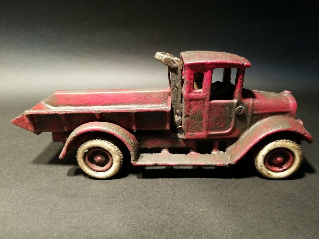 Cast Iron Red Dump Truck Flat bed Car Rubber Wheels: 10 1/4" Long x 3 1/4" Wide 4 1/8" Tall Such a neat reproduction cast iron tow truck! As you can see this heavy cast iron truck was wonderfully hand painted and distressed to look original. The car is 