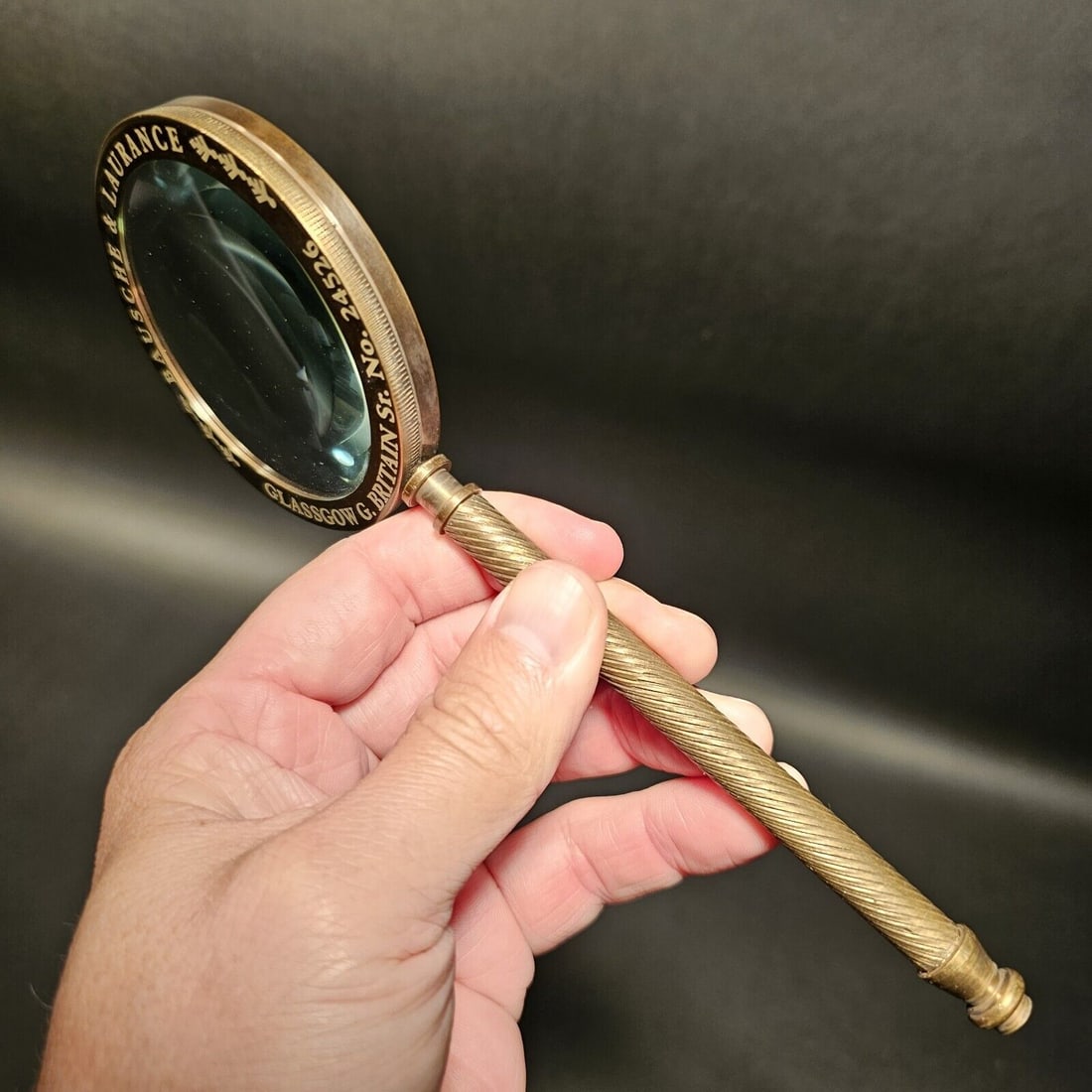 Brass Magnifying Glass "Bausche & Laurance": 8" Long x 3 1/4" Wide Wonderful reproduction vintage brass magnifying glass. Around the edge of the magnifying glass it says "Bausche & Laurance Glassgow G Britian Sr. No. 24526". Nice heavy quality p