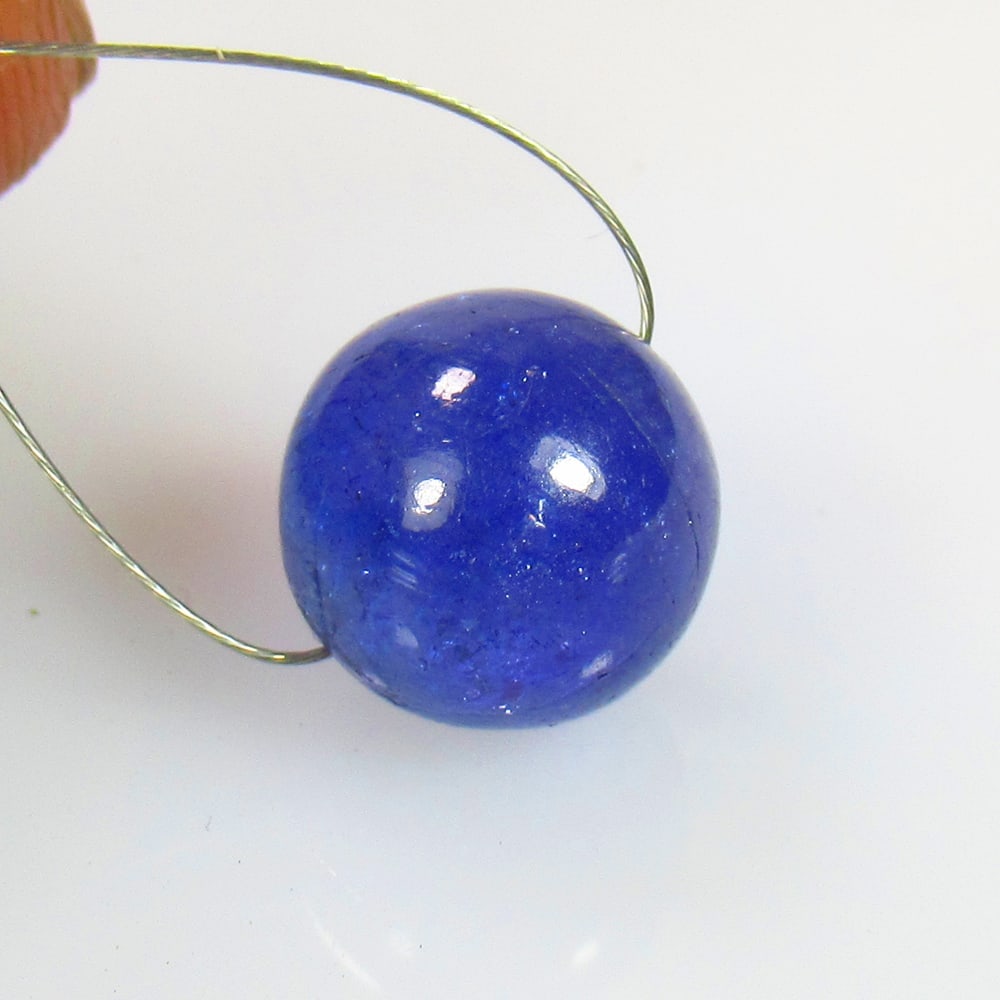 9.60 Ctw Natural Drilled Tanzanite Round Ball Beads: Title: 9.60 Ctw Natural Drilled Tanzanite Round Ball Beads Stone Clarity: Transparent Gemstone:Natural Tanzanite Beads Carat Weights: 9.6 Size/Dimensions: 10.30 x 10.30 mm Additional Info:Drille Round