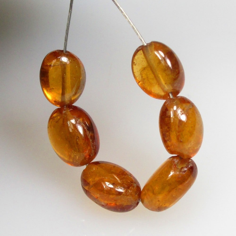 6.07 Ctw Natural 6 Hessonite Garnet Dumble Beads: No Reserve! Title: 6.07 Ctw Natural 6 Hessonite Garnet Dumble Beads Stone Clarity: Transparent Gemstone:Natural Hessonite Garnet Beads Carat Weights: 6.07 Size/Dimensions: 4.5x2.9- 4.8x2.8 mm / 6 Pc's