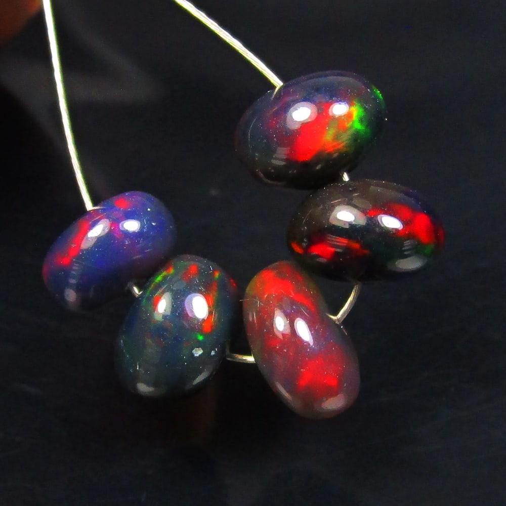 5.01 Ctw Natural 5 Ethiopian Drilled Black Fire Opal Beads: No Reserve! Title: 5.01 Ctw Natural 5 Ethiopian Drilled Black Fire Opal Beads Stone Clarity: Transparent Gemstone:Natural Opal Beads Carat Weights: 5.01 Size/Dimensions: 6.50 - 7.20 mm / 5 Pc's Additi