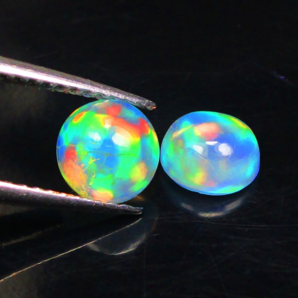 1.38 Ctw Natural Ethiopian Multicolor Opal Round Pair: No Reserve! Title: 1.38 Ctw Natural Ethiopian Multicolor Opal Round Pair Stone Clarity: Translucent Gemstone:Natural Opal Carat Weights: 1.38 Size/Dimensions: 6.00 x 6.00 x 3.30 mm / 2 Pc's Additional