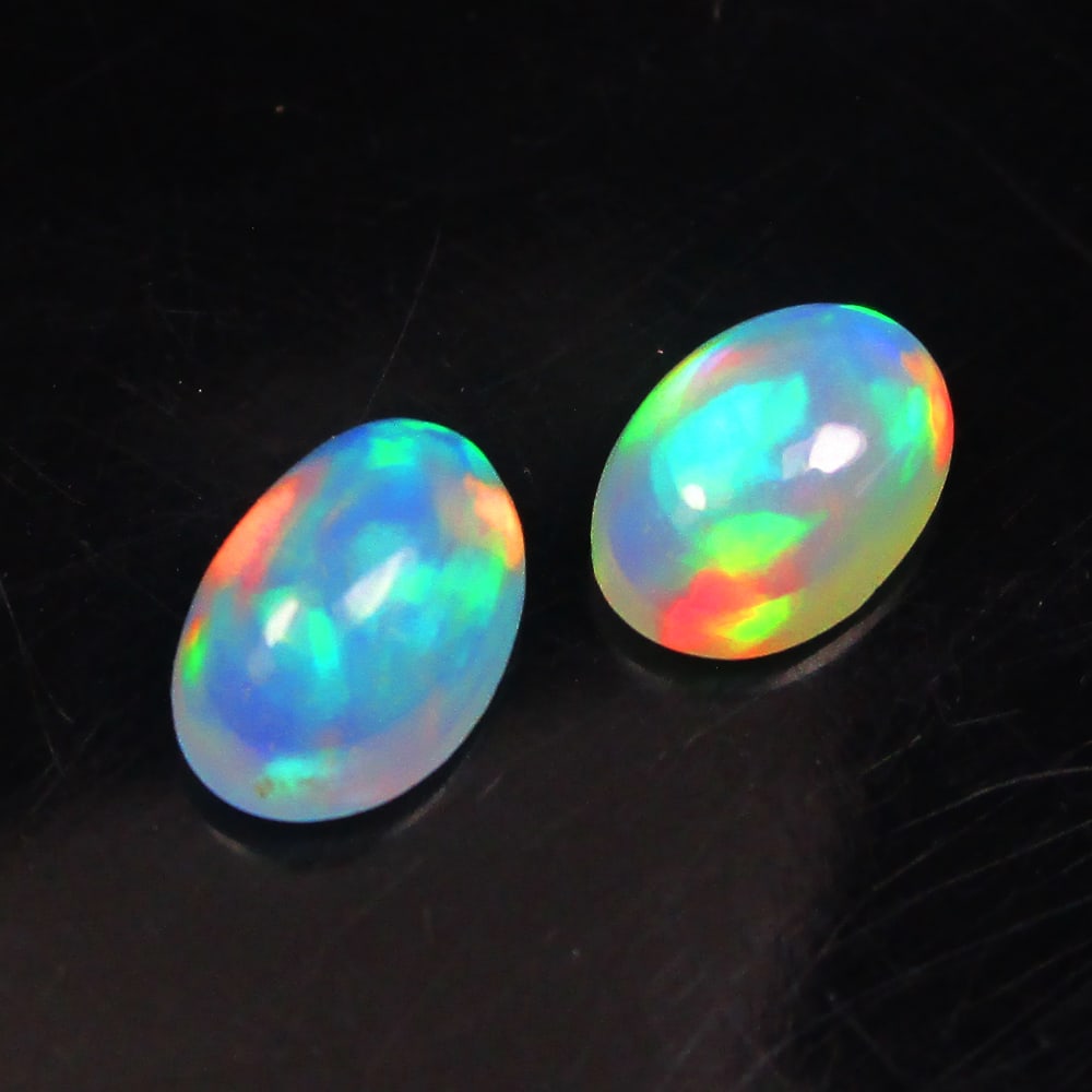 0.70 Ctw Natural Ethiopian Multicolor Opal Oval Pair: No Reserve! Title: 0.70 Ctw Natural Ethiopian Multicolor Opal Oval Pair Stone Clarity: Translucent Gemstone:Natural Opal Carat Weights: 0.7 Size/Dimensions: 6.10 x 4.10 x 2.70 mm / 2 Pc's Additional I
