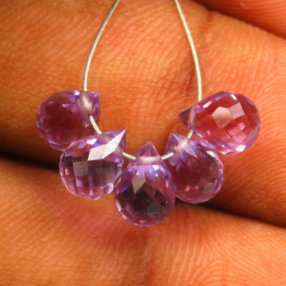 4.14 Ctw Natural 5 Drilled Purple Amethyst Pear Drop Beads: No Reserve! Title: 4.14 Ctw Natural 5 Drilled Purple Amethyst Pear Drop Beads Stone Clarity: Transparent Gemstone:Natural Amethyst Beads Carat Weights: 4.14 Size/Dimensions: 6.4x3.5 - 7.1x3.6 mm / 5 P