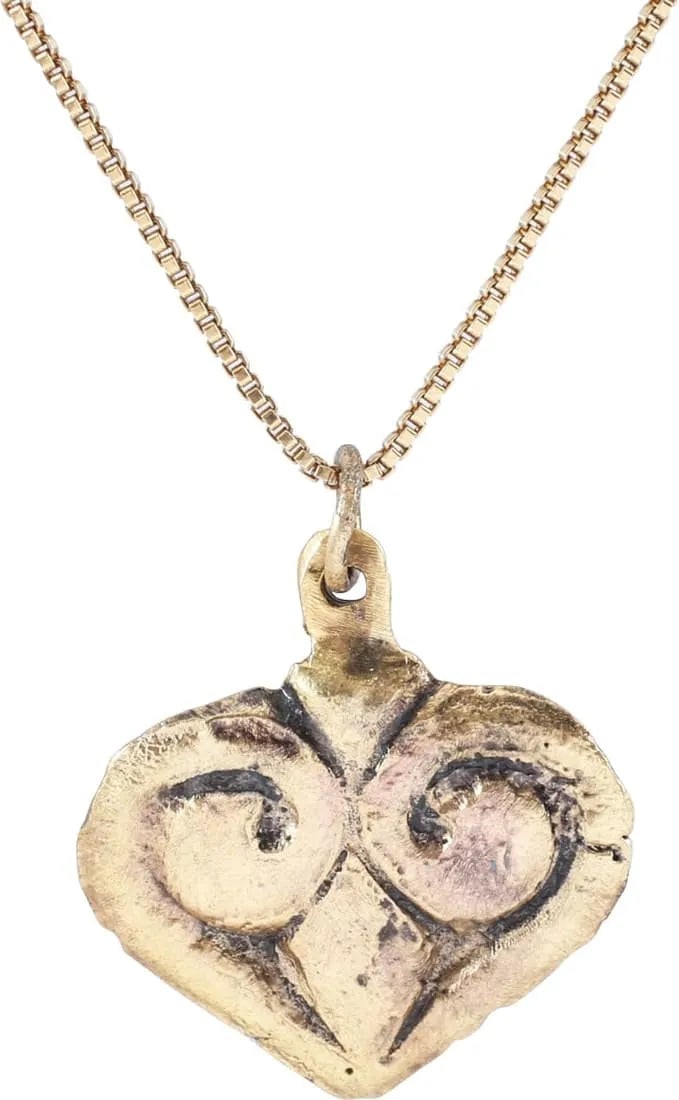 ANCIENT VIKING HEART PENDANT NECKLACE 11TH CENTURY AD: A fine example in its fully evolved form. Just OVER 5/8” height. Iconic fully developed cusped top full form. The broad raised borders forming the cusp and continuing as the top members of the c
