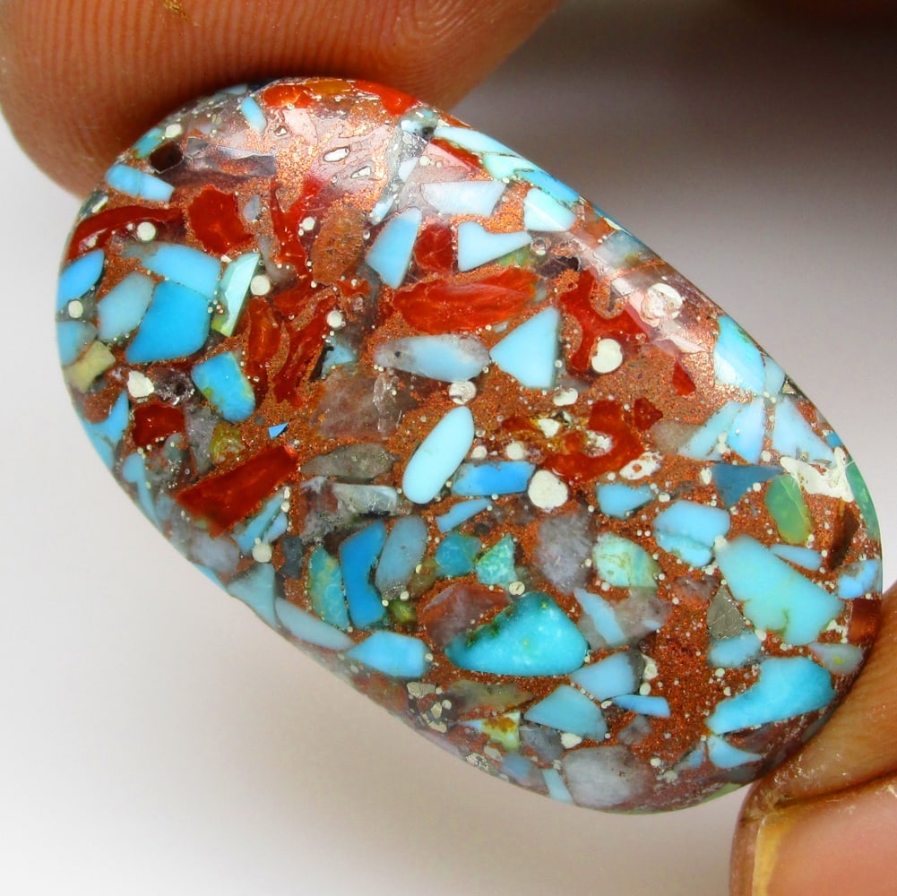19.70 Ctw Natural Coral Turquoise Oval Cab: Title: 19.70 Ctw Natural Coral Turquoise Oval Cab Stone Clarity: Opaque Gemstone:Natural Coral Carat Weights: 19.7 Size/Dimensions: 30.20 x 17.20 x 4.70 mm Additional Info:Excellent Art on Top / Nice 